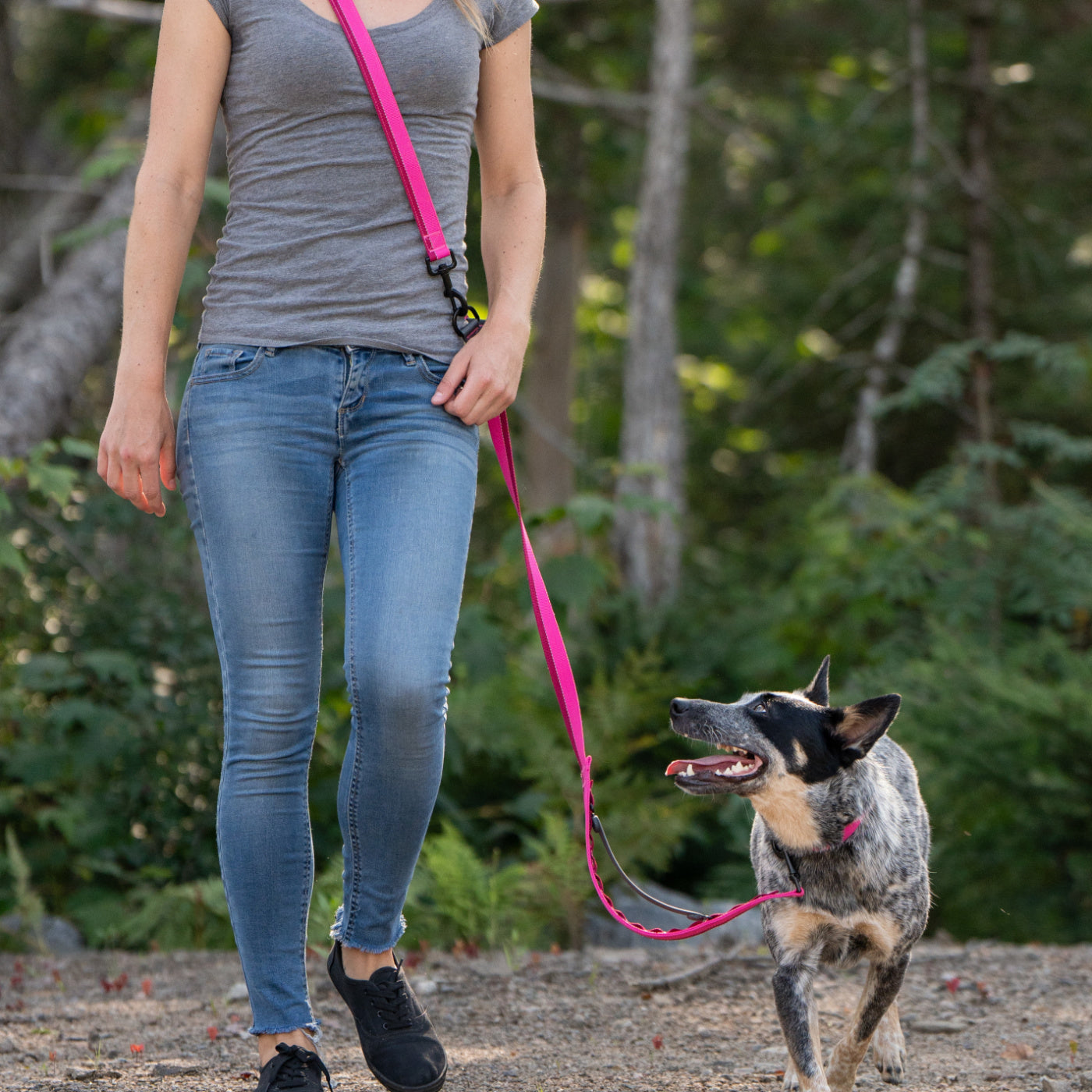 Woman and her medium dog wearing a pink Nuvuq multifunctional shoulder leash